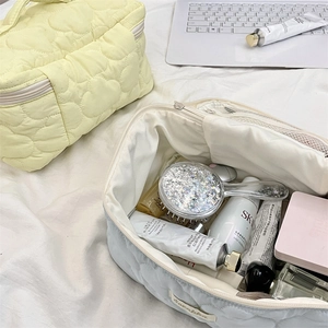 Detailed interior of quilted cosmetic bags showing large capacity for skincare tools