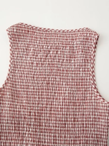 Detailed close-up of red and white gingham smocking fabric on this stylish midi dress