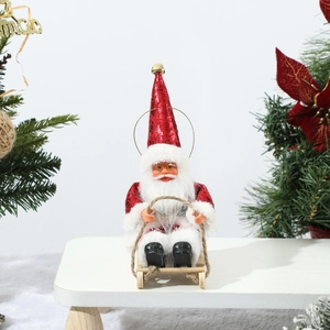 Detail of a decorative Santa Claus on a wooden sleigh with festive holiday scenery