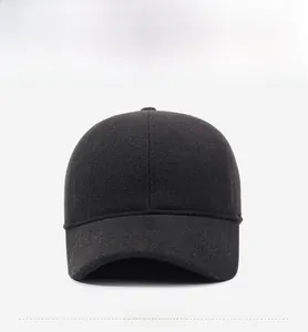 Detailed front view of a dark grey wool baseball cap with a subtle metal logo plate