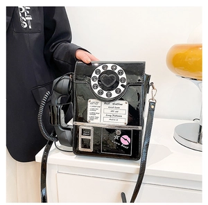 Detail of creative vintage phone bag featuring black faux leather and heart dial
