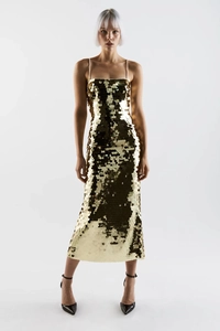 Detailed view of shimmering gold sequins on a backless evening dress with thin straps