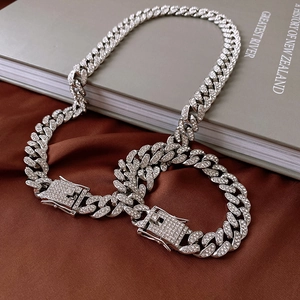 Detailed close-up of a silver Cuban link chain with sparkling white rhinestones
