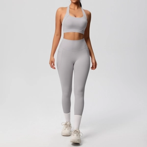 Detail of high-waisted gray yoga leggings featuring a functional side pocket for storage