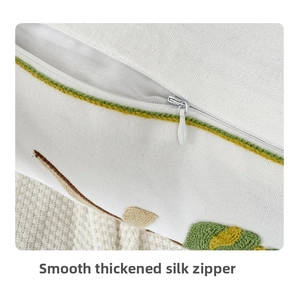 Close-up of high-quality smooth hidden zipper on white embroidered floral cushion cover