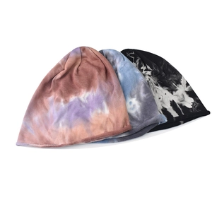 Detailed knit texture and vibrant tie-dye patterns on three different soft beanies