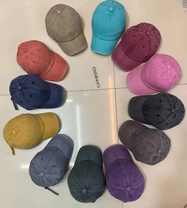 Overhead view showing various colors of vintage washed cotton baseball caps for children