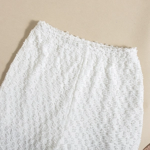 Detailed macro view of white textured seersucker fabric and elastic waistband