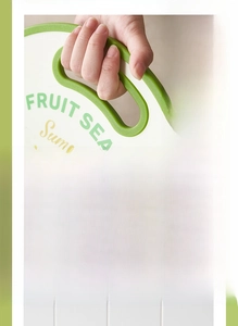 Detail of food-grade plastic fruit cutting board with hanging hole and green floral pattern