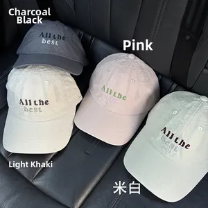 Top view of four cotton baseball caps in charcoal, pink, khaki, and cream with embroidery