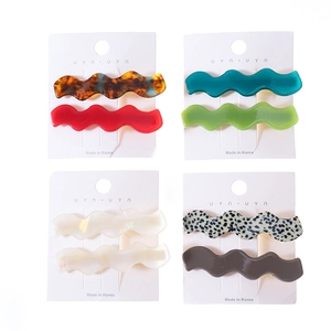 Set of 8 wavy leopard print hair clips in various colors displayed on white cards