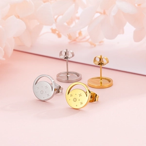 Detail view of round gold and silver star moon stud earrings with butterfly backings
