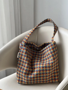 Close-up detail of vintage houndstooth knit fabric and simple wish woven label