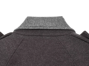 Close-up of contrast collar stitching and dark grey wool fabric texture on casual coat