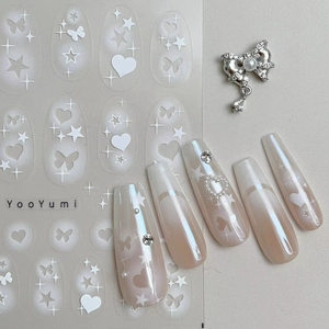 Detail view of 2D nail stickers with gradient pink star, heart, and butterfly designs