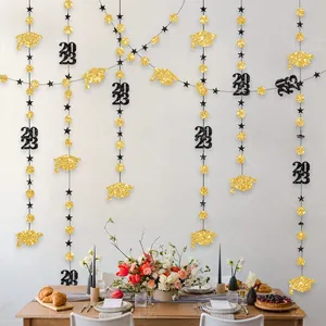 Detail of 2023 graduation black and gold glitter star and cap hanging garland decor