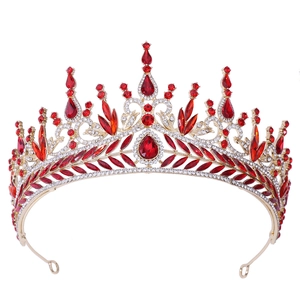 Detailed macro view of luxury Baroque bridal crown with red crystals and gold alloy finish