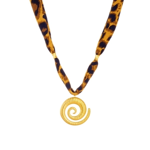 Macro detail of golden spiral pendant with trendy leopard print fabric ribbon chain necklace