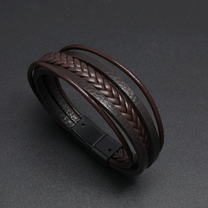 Detail of dark brown braided leather multilayer bracelet with black magnetic buckle