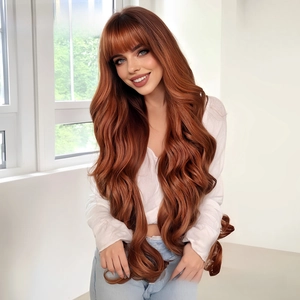 Detailed view of long wavy auburn wig with bangs on model in natural light