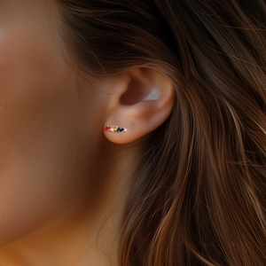 Macro shot of colorful geometric baguette-cut crystal stud earrings worn on female ear