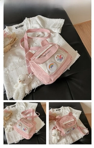 Detailed view of pink canvas crossbody bag with cute animal ears and plush bear charm