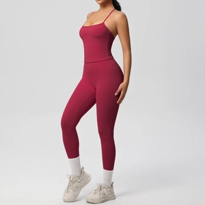 Detail of high-waist burgundy yoga set with thin strap tank top and leggings on model