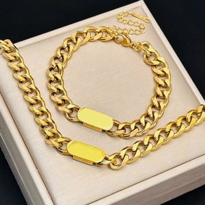 Macro detail of gold-plated stainless steel cuban chain set with blank rectangle tags