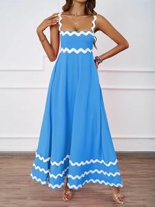 Detail of blue summer maxi dress featuring white wavy scallop trim and slim fit silhouette