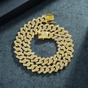 Macro shot of gold-plated 15mm Cuban chain with iced-out rhinestones and box clasp