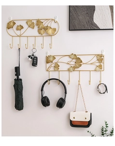 Detail of golden ginkgo leaf metal wall hooks showcasing elegant texture and storage