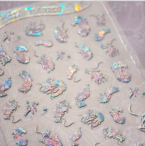 Macro detail of holographic dragon nail stickers with traditional Chinese art pattern