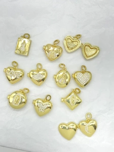 Detailed view of assorted gold-plated photo locket pendants with zircon stones and patterns
