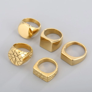 Macro detail of five minimalist gold-plated stainless steel geometric rings set