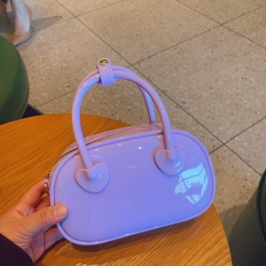 Glossy purple PVC jelly mini handbag with heart-shaped handle joints and gold zipper