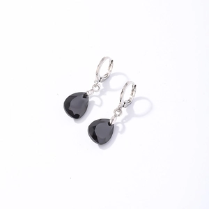 Détail de boucles d'oreilles argentées avec pendentifs en cristal noir facetté