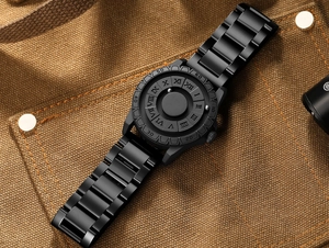 Macro detail of matte black magnetic ball watch with 3D Roman numeral dial markers