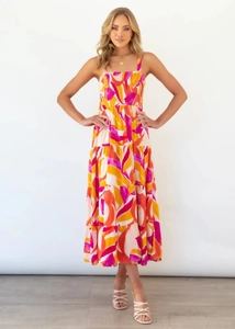 Detail of vibrant tiered floral maxi dress with smocked bodice and square neckline