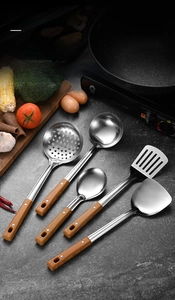 Detailed view of stainless steel kitchen utensil set with ergonomic wood-grain riveted handles