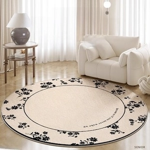 Detail of round beige rug with black floral borders and artistic script in a French living room