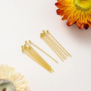 Macro view of 14K gold plated ball head pins for professional DIY jewelry crafting