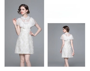 Vue détaillée de la robe en jacquard blanc avec dentelle délicate et volants élégants