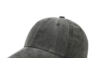Detailed macro view showing the washed cotton texture and stitching of this baseball cap