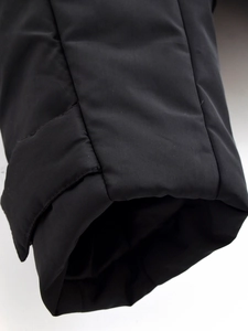 Detailed close-up of windproof black cuffs showing durable stitching and high-density fabric