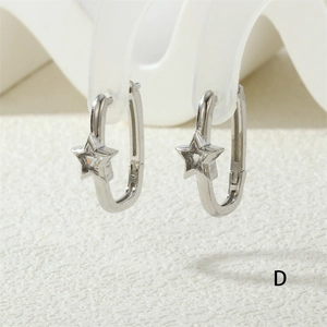 Macro shot of silver U-shaped hoop earrings featuring a sparkling star zircon pendant