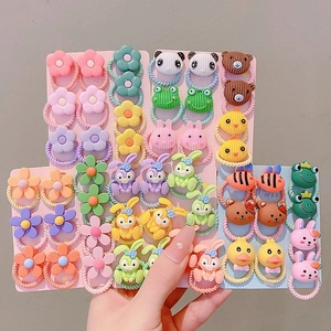 Close-up of children's colorful elastic hair bands with cute resin cartoon animal characters
