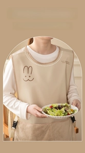 Detail of beige waterproof apron featuring rabbit print and absorbent towel side panels
