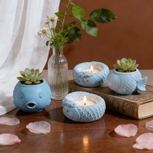 Detailed view of light blue fish-shaped ceramic flower pots and tea light candle holders