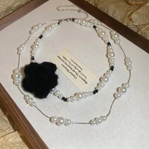 Elegant double-layer pearl necklace with a large black crochet flower pendant for women