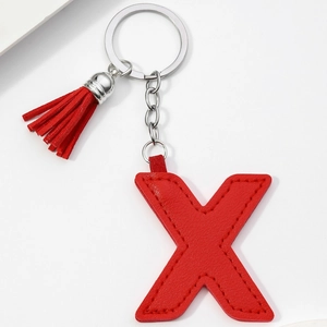 Detail of red PU leather letter X keychain with matching tassel and silver metal ring